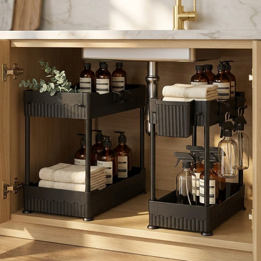 Luxury black under-sink organizer set in white oak designer kitchen cabinet with Aesop bottles — At Home For You